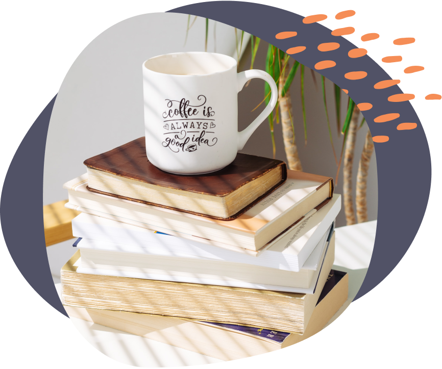 a screenshot of a coffee mug on top books