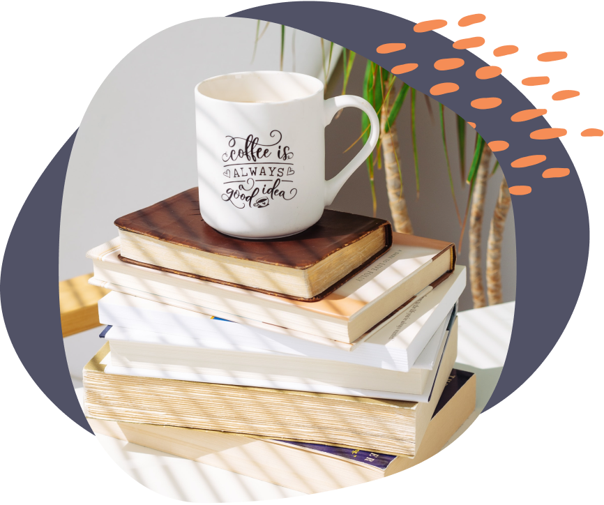 a screenshot of a coffee mug on top books