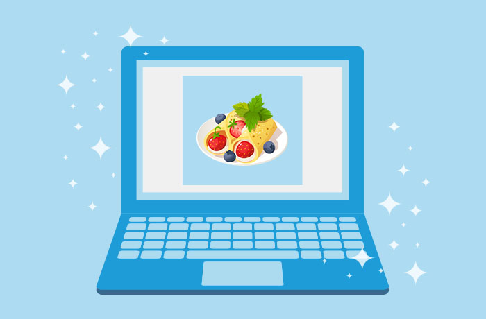 Graphic of blue laptop in front of a blue background with an image of crepes filled with fresh fruit