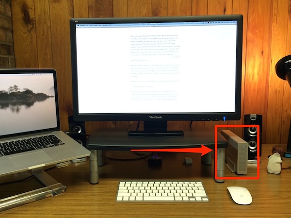 Computer screen, laptop, keyboard, and external hard drive. 