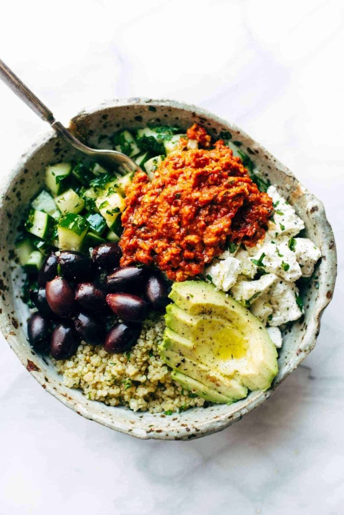 A mix of quinoa, cucumbers or kale or spinach, feta cheese, kalamata olives, and pepperoncini