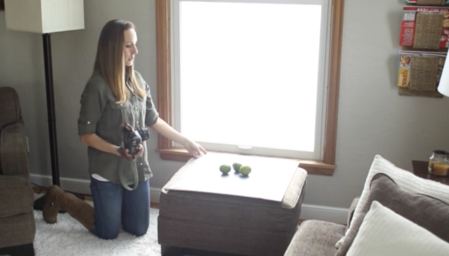 Lindsay Ostrom shooting a photo of limes in natural light