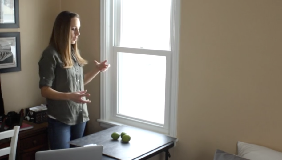 Lindsay Ostrom shooting a photo of limes against a black board 