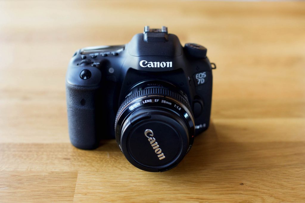 Canon 7D Mark II camera on a wood table