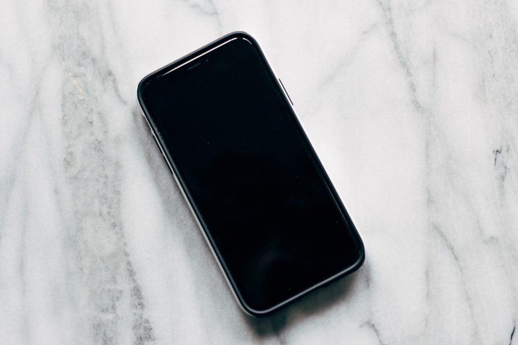 iPhone resting on a marble surface