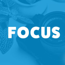 An image of a camera on a table and the title of the 228th episode on the Food Blogger Pro Podcast, 'Focus.'