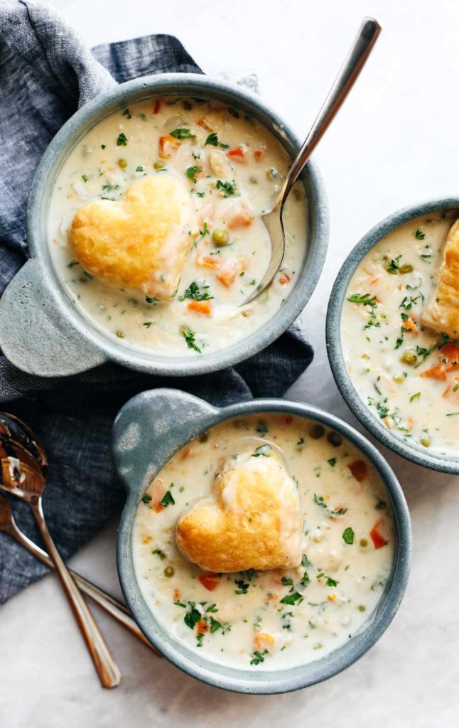 Three bowls of chicken pot pie soup photographed from overhead