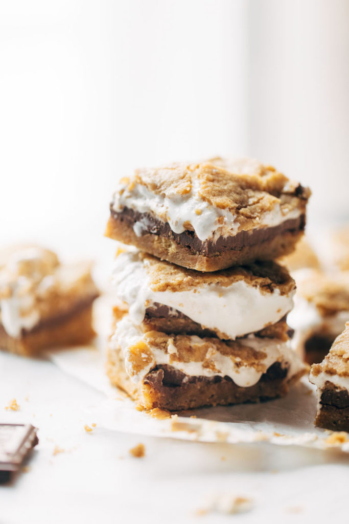 Several s'mores bars stacked on top of each other and shot at table height