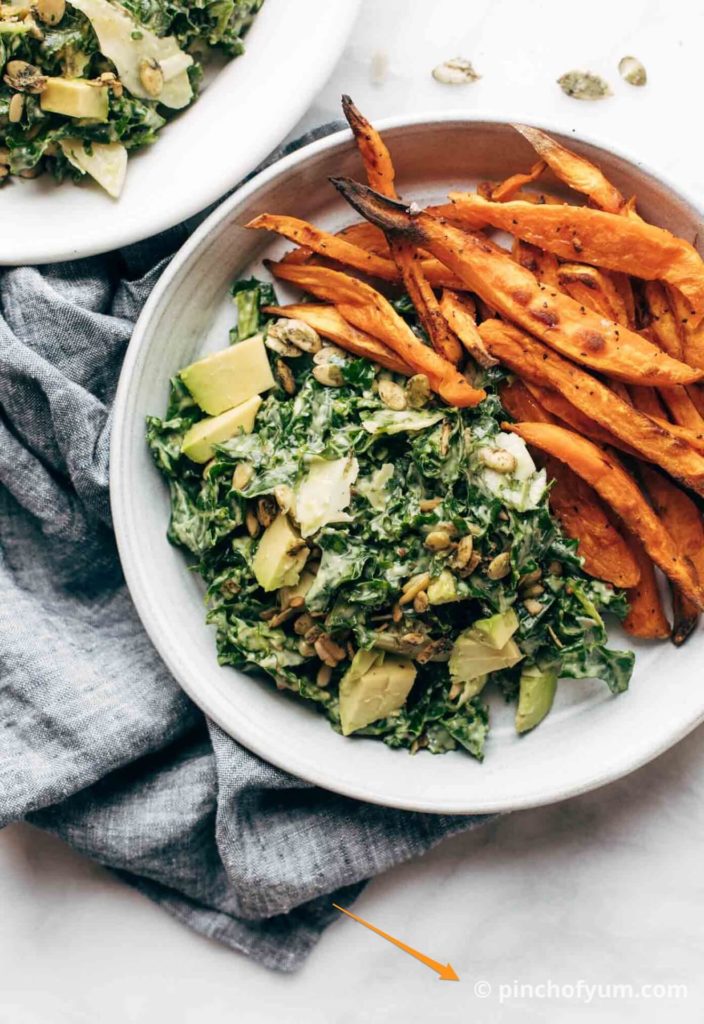 A salad on a plate with an orange arrow pointing to a watermark