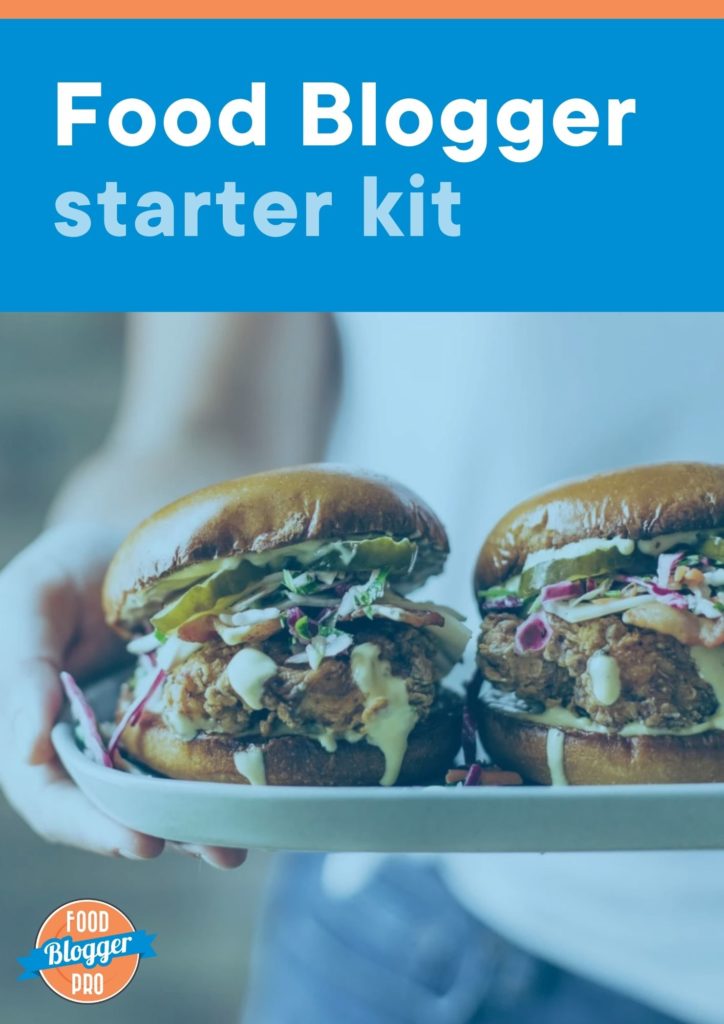 The cover to our Food Blogger Starter Kit ebook with a photo of a girl holding chicken sandwiches