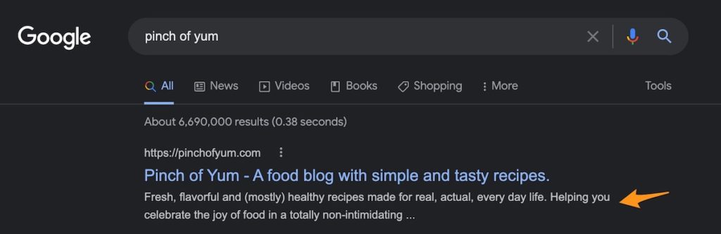 an orange arrow pointing to the meta description in a Google Search result for Pinch of Yum 