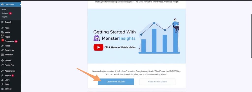 The MonsterInsights onboarding page with an orange arrow pointing to Launch the Wizard