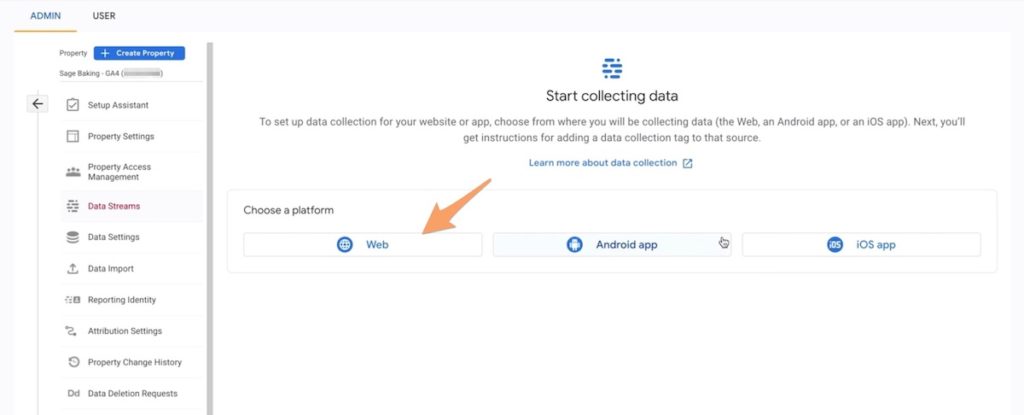 An orange arrow pointing to the web data stream option in Google Analytics