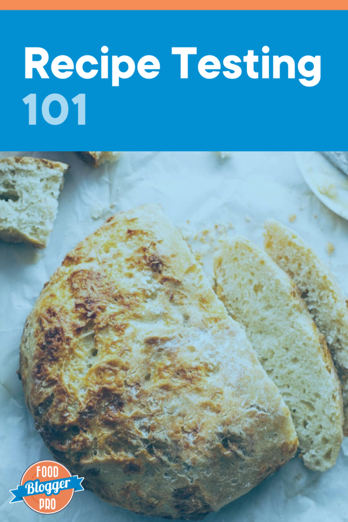A loaf of cheesy bread that reads "recipe testing 101" and has the Food Blogger Pro logo on it. 