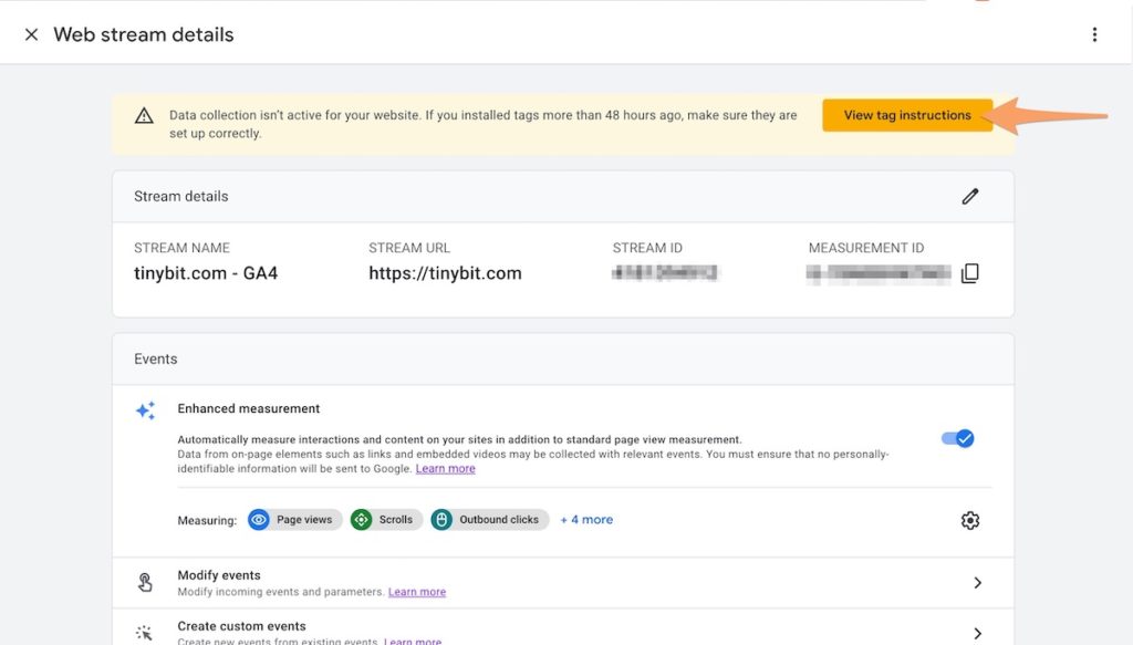 An orange arrow pointing to the View tag instructions button in GA4 for the web stream
