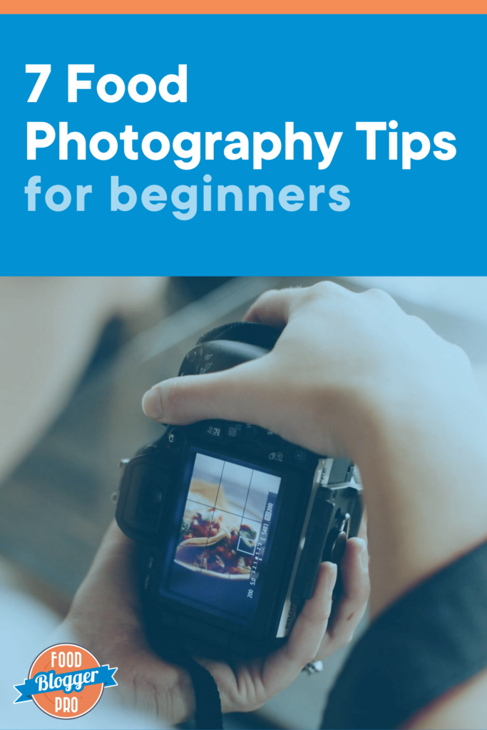 A close-up photograph of hands holding a DSLR camera with a photo of tacos on the screen and the title of this post "7 food photography tips for beginners"