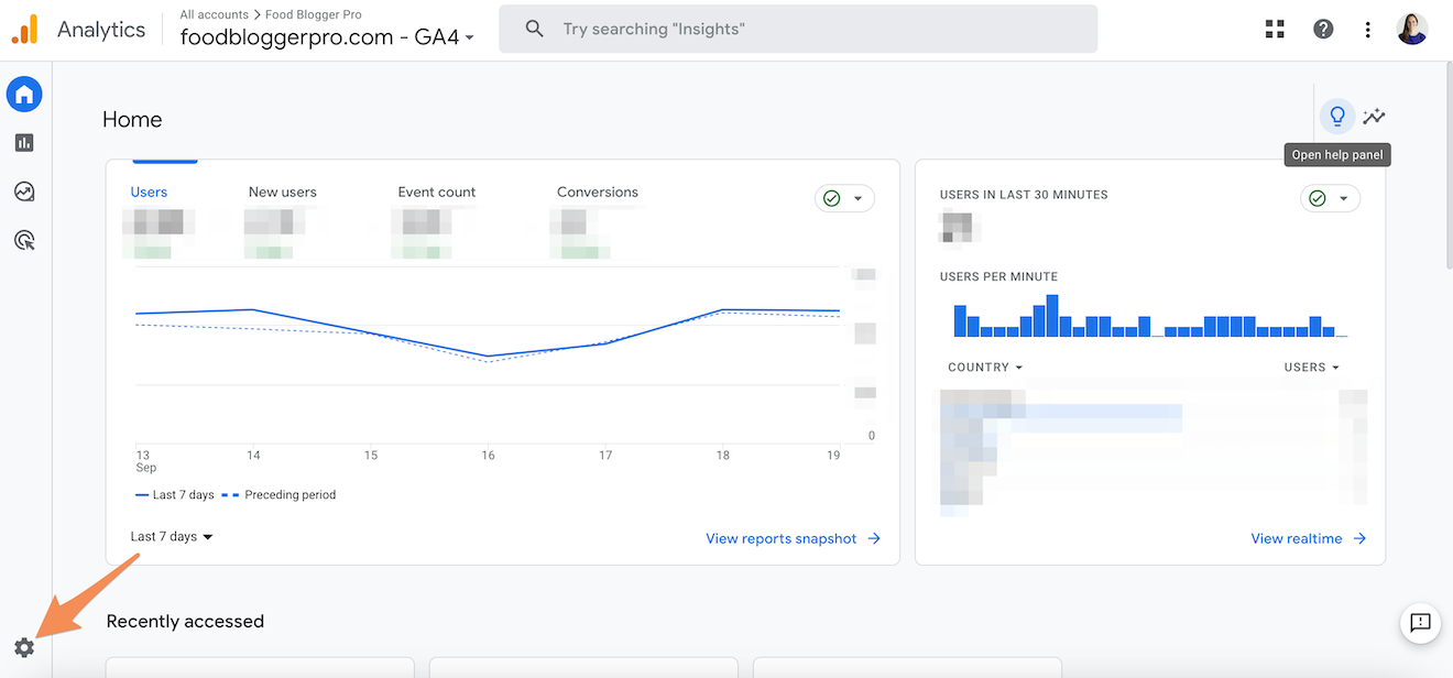 A screenshot of the GA4 homepage with an orange arrow pointing to the admin gear.